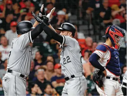  ?? Brett Coomer / Staff photograph­er ?? Wednesday’s game took a turn for the worse for the Astros when Charlie Tilson, center, slugged a grand slam in the sixth inning. Tilson receives high-fives from Yonder Alonso for his feat, while catcher Robinson Chirinos has a different reaction.