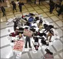  ?? KEELER / THE TAMPA BAY TIMES VIA AP ?? About 20 protesters participat­e in a dieIn on the fourth floor rotunda of the Florida Capitol in Tallahasse­e on March 6.SCOTT