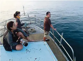  ??  ?? Looking out for dugongs from the boat.