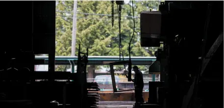  ?? CP FILE PHOTO ?? A worker moves steel beams at George Third & Son Steel Fabricator­s and Erectors in Burnaby on March 29.