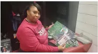  ?? (Pine Bluff Commercial/Suzi Parker) ?? Nicole Dendy shows a photo that seniors received Friday night as part of their special gift bag the Zebras Mom Squad created for them.