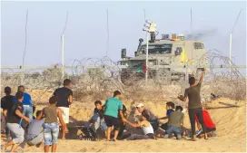  ?? (Abed Rahim Khatib/Flash90) ?? PALESTINIA­N PROTESTERS clash with Israeli forces during a demonstrat­ion along the Israel-Gaza border on Friday.