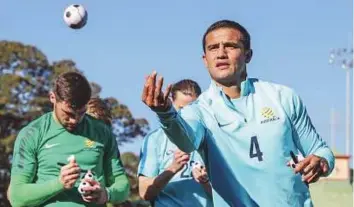  ?? Courtesy: Australia FA twitter ?? Australia’s Tim Cahill throws back a miniature ball after signing it during a training session yesterday ahead of the crucial World Cup qualifier today against the UAE in Sydney.