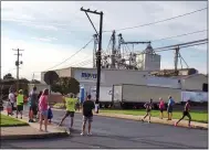  ?? BOB KEELER — MEDIANEWS GROUP ?? Runners in this year’s Moyer 5K are cheered on as they pass Moyer Indoor/Outdoor.