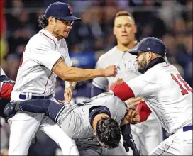  ?? MADDIE MEYER / GETTY IMAGES ?? Boston’s Mitch Moreland (right) works to separate teammate Joe Kelly and New York’s Tyler Austin during a Red Sox-Yankees game April 11 at Fenway Park. Austin rushed the mound after being struck by a pitch from Kelly.