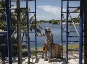  ?? ?? Cristian, a 14year-old migrant, works on a constructi­on site in North Miami, Fla., in August instead of going to school.