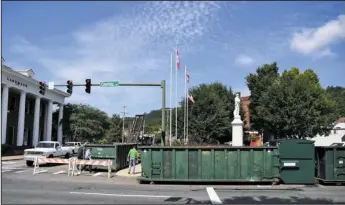  ?? The Sentinel-Record/Mara Kuhn ?? GIRDING THE SQUARE: The city’s solid waste department positioned roll-off containers near the Confederat­e Square memorial Friday in anticipati­on of today’s Confederat­e demonstrat­ion on Arlington Lawn. The city said the containers will prevent vehicles...