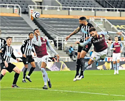  ??  ?? Late drama: Jamaal Lascelles powers in Newcastle’s stoppage-time equaliser to deny Aston Villa victory at St James’ Park last night