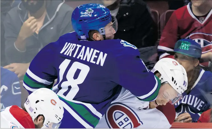  ?? — THE CANADIAN PRESS FILES ?? The Canucks’ Jake Virtanen, checking Montreal Canadiens’ Lars Eller earlier this season, was suspended two games for a hit on San Jose’s Roman Polak.