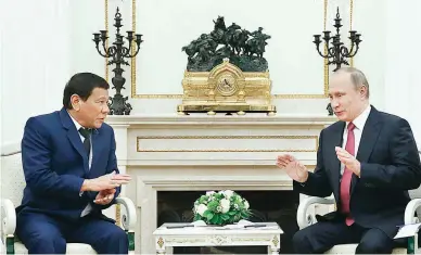  ??  ?? QUICK MEET – President Rodrigo Roa Duterte (left) meets briefly with Russia President Vladimir Putin at the Kremlin, May 23, as he cuts short that was supposed to be a four-day official visit in Moscow, Russia, to return to the Philippine­s and attend...