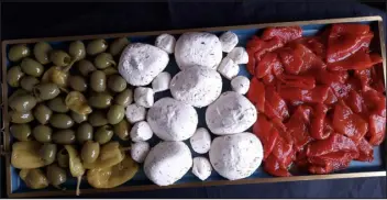  ?? BILL ST. JOHN, SPECIAL TO THE DENVER POST ?? An antipasto platter of green olives, white cheese and smoked red peppers laid out in imitation of the flag of Italy.