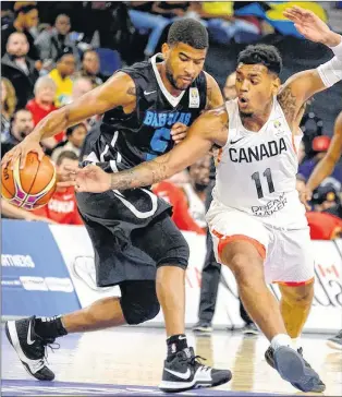  ?? CANADIAN PRESS FILE PHOTO/TED PRITCHARD ?? ABOVE: In this Nov. 24, 2017 file photo, Canada’s Xavier Rathanmaye­s (11) tries to steal the ball from Bahamas’ L.J. Rose during a FIBA World Cup qualifying game in Halifax. Canada already knows it will be advancing to the next round of qualifying for...