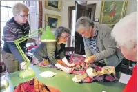  ??  ?? Dunollie’s heritage director Catherine Gillies providing volunteers with training in handling ancient textiles.