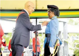  ?? CONTRIBUTE­D PHOTOS ?? Sheelyn Manya receives the Badge of Honour for Meritoriou­s Service from Governor General Sir Patrick Allen.