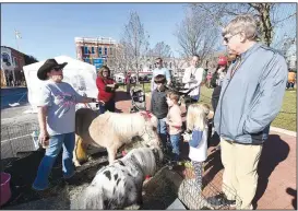  ?? NWA Democrat-Gazette/FLIP PUTTHOFF ?? Rebecca Christian (left) with Autumn’s ReRide Youth Ranch shows Saturday miniature horses she brought to the Winter Market and Arts Festival on the Bentonvill­e square.