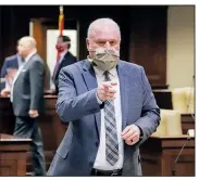  ?? (Arkansas Democrat-Gazette/John Sykes Jr.) ?? State Sen. Jim Hendren, wearing a personaliz­ed mask, points toward a fellow legislator before a meeting of the Joint Budget Committee on Thursday in Little Rock.