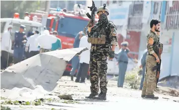  ??  ?? Afghan security forces keep watch at the site of a suicide attack in Kabul. — Reuters photo