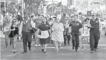  ??  ?? (From left) Union members Jennifer Patino, Vernisha Ward, Nympha Camacho, Glenna Bolster, David Saba and Jose Rivera lead a May Day march on the Las Vegas Strip in Las Vegas, Nevada. — AFP photo