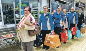  ??  ?? Anne celebrates at the end of her trolley dash with Aldi Oban staff.