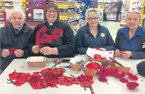  ??  ?? The Rev Maggie Hunt of St Margaret’s Church in Forfar with, from left, Mike Smith of the Forfar branch of the Royal Air Forces Associatio­n and Tesco staff Lyn Archer and Kerri Myles.