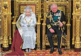  ?? VICTORIA JONES/POOL PHOTO ?? Queen Elizabeth II, with Prince Charles at her side, delivers a speech Oct. 14, 2019, at the official opening of Parliament in London. At 73, he is now King Charles III.