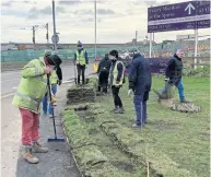  ?? PHOTOS: LHCRT ?? Trust volunteers working on the last section of hedging near the Birmingham Road roundabout.