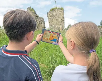  ??  ?? Cameron Robertson, 8, and Lily Riach, 10, exploring Fife with the app.