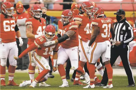  ?? David Eulitt / Getty Images ?? Kansas City quarterbac­k Patrick Mahomes is helped to his feet after taking a blow to the head that forced him to depart.