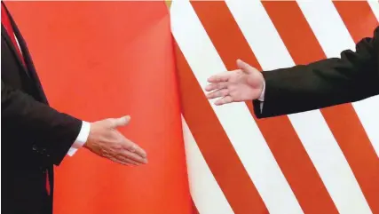  ?? — Reuters ?? US President Donald Trump and China’s President Xi Jinping shake hands after making joint statements at the Great Hall of the People in Beijing, China, November 9, 2017.