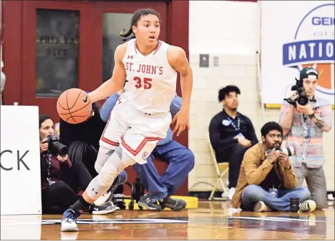  ?? Steven Ryan / Getty Images ?? Azzi Fudd in action against the Centennial in the semifinal of the GEICO High School National Tournament at Christ the King High School in 2019.