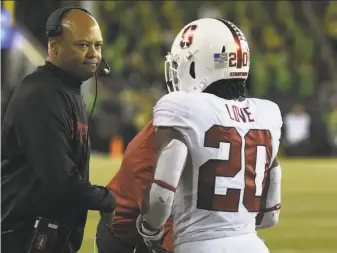  ?? Steve Dykes / Getty Images ?? Stanford head coach David Shaw greets Bryce Love after the running back scored a touchdown in a 38-31 win at Oregon on Saturday. The victory improved the Cardinal to 2-0 in the Pac-12.