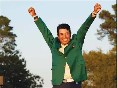  ?? Associated Press ?? Masters champion: Hideki Matsuyama, of Japan, celebrates after putting on the champion's green jacket after winning the Masters golf tournament on Sunday in Augusta, Ga.