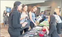  ?? KRISTIN LAM — STAFF PHOTOGRAPH­ER ?? Denise Young shares informatio­n about the County of Santa Clara Public Health Department’s resources with Hurjessica Birk and Rana Moradhasel, members of Active Minds at Sacramento State on Friday.