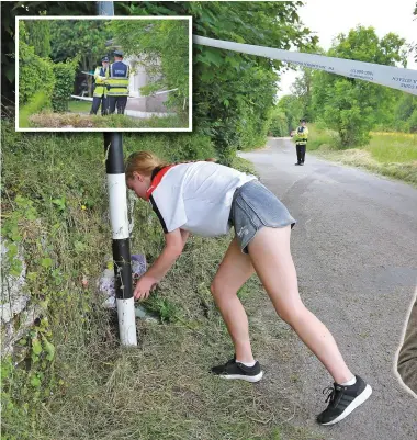  ?? Photo: Frank McGrath ?? A girl lays flowers at the house near Ballincoll­ig where Mikolaj Wilk was killed.