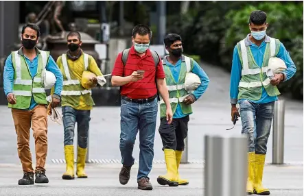  ?? — Reuters ?? Essential: Most foreign workers in Singapore are low-paid domestic workers or manual labourers, but it’s the number in PMET roles that irks Singaporea­ns vying for similar positions.