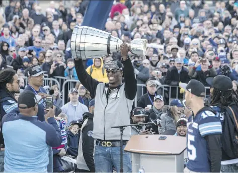  ?? PHOTOS: CHRIS YOUNG/THE CANADIAN PRESS ?? Toronto Argonauts running back James Wilder Jr. hoists the Grey Cup in front of fans gathered on Tuesday at Toronto’s Nathan Phillips Square, where the team celebrated its 27-24 win over Calgary Stampeders at the 105th Grey Cup in Ottawa.