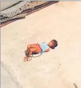  ?? SOURCED ?? A video grab shows the girl, her hands and legs tied, on the terrace of her home in northeast Delhi’s Khajuri Khas.