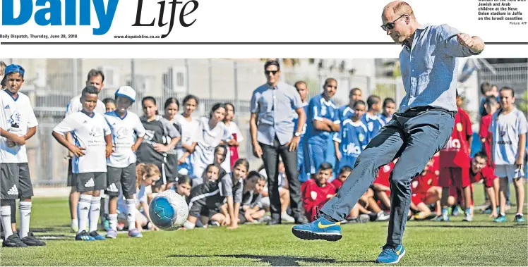  ?? Picture: AFP ?? GOAL: Britain’s Prince William on the field with Jewish and Arab children at the Neve Golan stadium in Jaffa on the Israeli coastline
