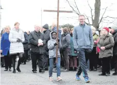  ??  ?? Clergy from the Ormeau Road in Belfast join together to carry the cross