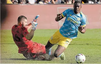  ?? MARCIO JOSE SANCHEZ THE ASSOCIATED PRESS ?? Goalkeeper Maxime Crépeau, left, from Canada, collides with Philadelph­ia Union forward Cory Burke in extra time during an MLS Cup soccer match Saturday in Los Angeles.