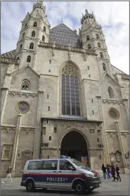  ?? (AP/Heinz-Peter Bader) ?? A police van drives past St. Stephen’s Cathedral on Wednesday in Vienna, Austria.