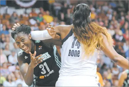  ?? FRED BECKHAM/AP PHOTO ?? Tina Charles of the Liberty looks for a foul call while being guarded by Kelsey Bone of the Sun in the first half of Sunday’s WNBA game at Mohegan Sun Arena. The Sun stretched their winning streak to four with a 76-72 victory.