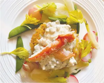  ??  ?? Crab and potato cakes are served with remoulade and crisp marinated vegetables.