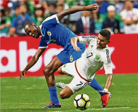  ??  ?? No, you don’t: Mexico’s Orbelin Pineda (right) is fouled by Curacao’s Quentin Martinus in the Concacaf Gold Cup Group C match at the Alamodome Arena in San Antonio on Sunday. — AFP