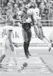  ?? Gene Schallenbe­rg / Huntsville Item ?? Sam Houston State receiver Nathan Stewart (81) can only watch as North Dakota State’s Tre Dempsey (3) and Marquise Bridges celebrate an intercepti­on.