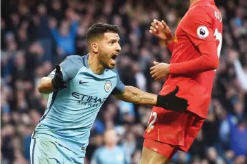  ??  ?? Manchester City’s Argentinia­n striker Sergio Aguero (L) celebrates after scoring during the English Premier League football match between Manchester City and Liverpool at the Etihad Stadium in Manchester, north west England. - AFP photo