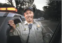  ??  ?? Right: Sonoma County Sheriff ’s Deputy Mark Aldridge helped save 35 people in this lot as the Tubbs Fire raged nearby.