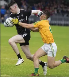  ??  ?? Luke Towey of Sligo evades the challenge of Leitrim’s Sean Chandler.