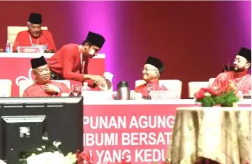  ??  ?? Syed Saddiq shakes hand with Dr Mahathir after delivering his speech. — Bernama photo