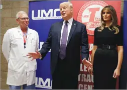  ?? The Associated Press ?? U.S. President Donald Trump makes a few comments after meeting with survivors of Las Vegas’s mass shooting at the University Medical Center. First lady Melania Trump and surgeon Dr. John Fildes listen.